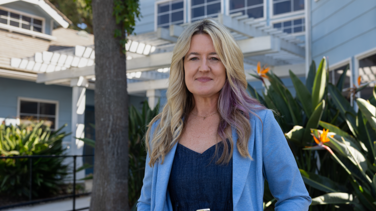 Dr Young stands in front of RICA building