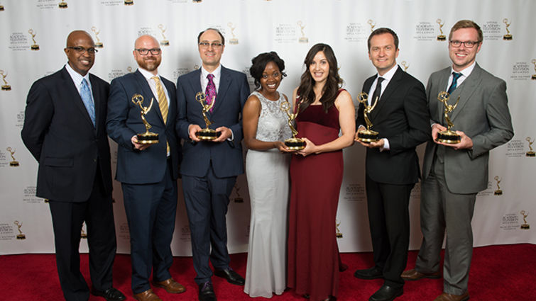 Group photo of Advancement Films members accepting their Emmy Awards