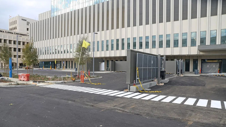 The south side frontage road and parking lots adjacent to the two emergency departments have now received a final layer of asphalt and paint Emergency department access and parking