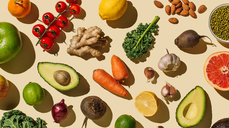 Pattern of variety fresh of organic fruits and vegetables and healthy vegan meal ingredients on beige background. 