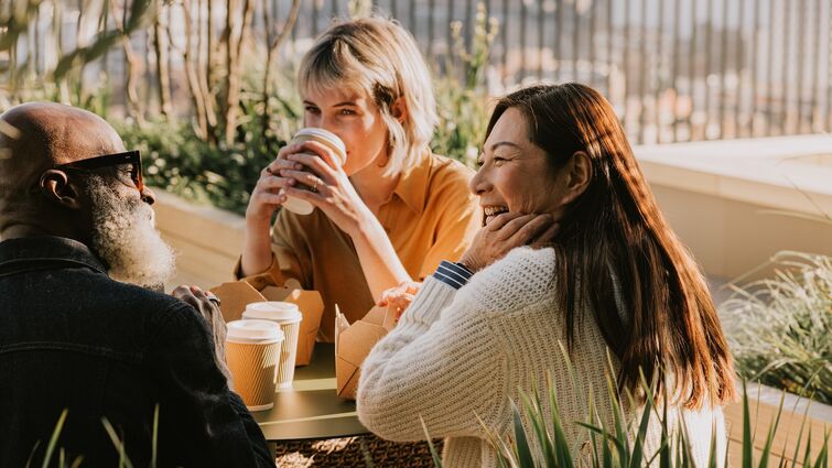 A group of coworkers enjoy an outdoor lunch