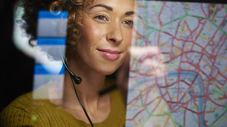 A woman looks happy while viewing an online map