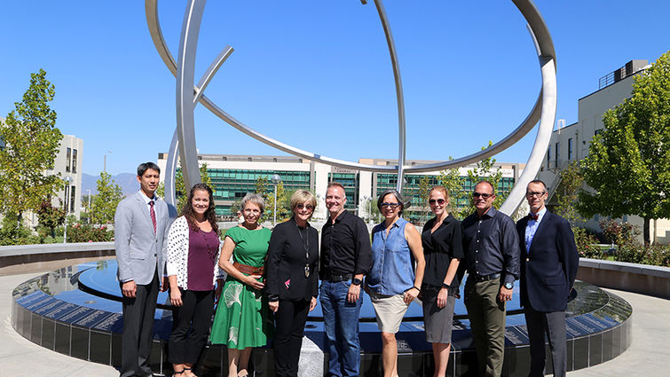 group of men and women pose on campus