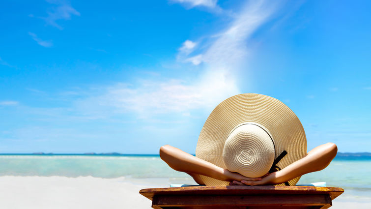 Woman sitting in chair with hat on