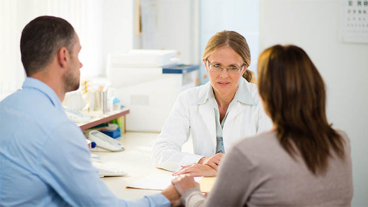 Start the conversation about the cancer process with both a loved one and a physician. Doctor consulting with patient