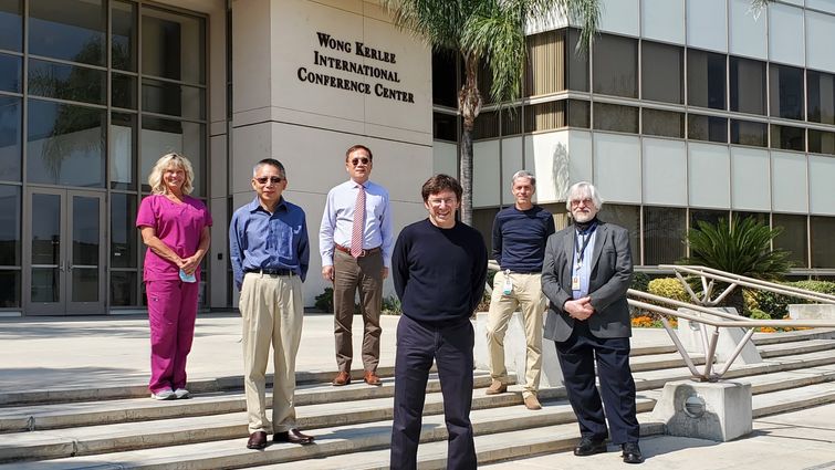 group stands in front of a building