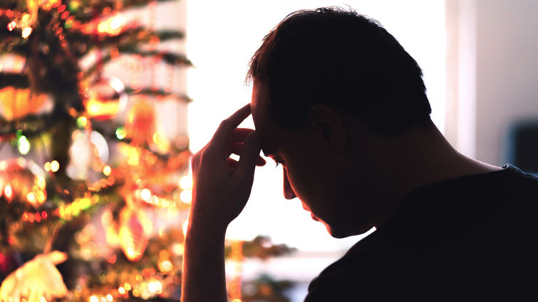 Marriage and family therapist, Stephen Graves, says adults can feel anxious in environments where trauma occurred at a young age. Sad on Christmas. Unhappy, lonely or tired man with stress, grief or depression. Family fight, loneliness, frustration or money problem on Xmas. stock photo