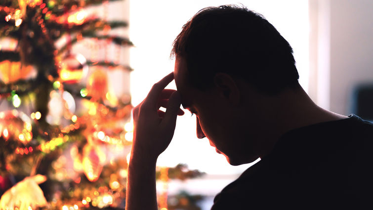 Sad on Christmas. Unhappy, lonely or tired man with stress, grief or depression. Family fight, loneliness, frustration or money problem on Xmas. stock photo