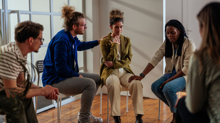 People attending self help therapy group meeting in community center stock photo