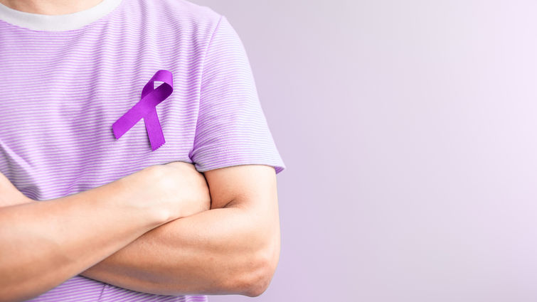 Man wearing purple ribbon for testicular cancer awareness