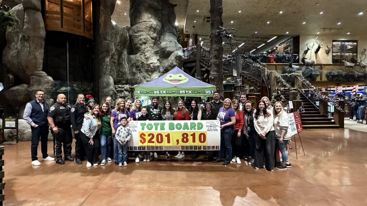 Staff and volunteers hold final total check