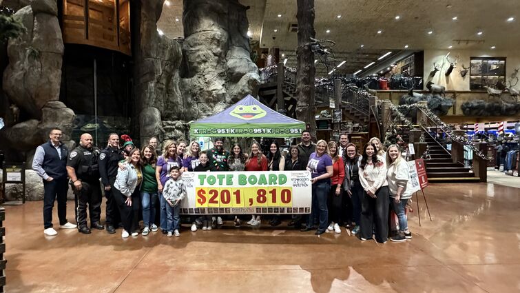 Staff and volunteers hold final total check