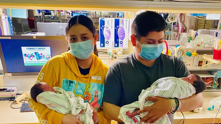 Violeta Andrade and her boyfriend, Marco Benitez, hold their newborn twins in the neonatal intensive care unit of the LLU Medical Center.