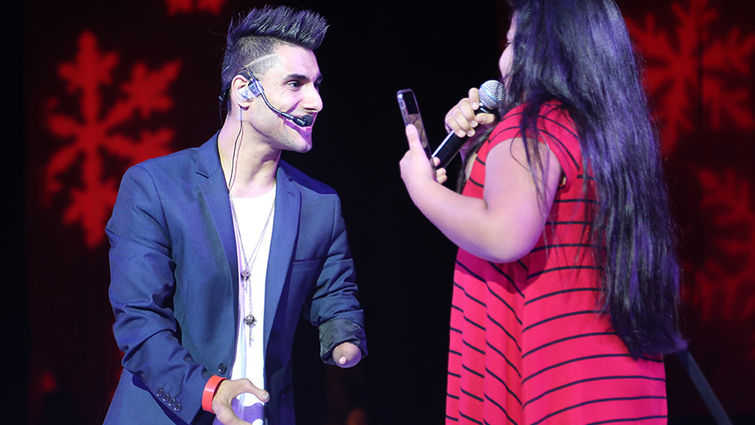 International singing sensation Emmanuel Kelly invited a young fan up on stage to sing with him during his performance at the 14th annual Celebration Dinner for the PossAbilities program on Dec. 3.