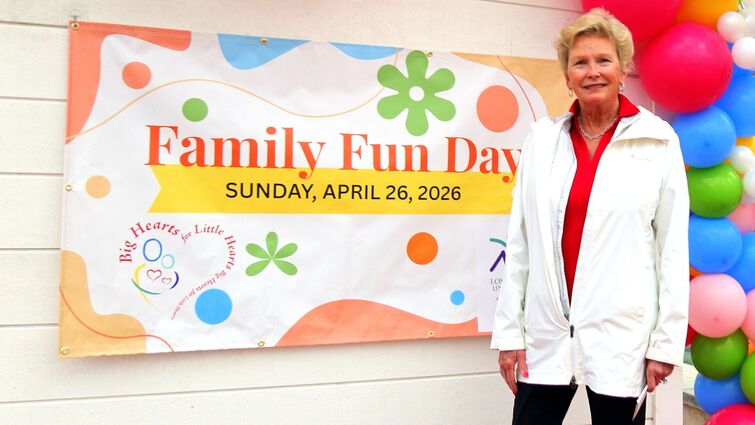A colorful “Family Fun Day” banner displayed outdoors next to balloons at the event entrance.