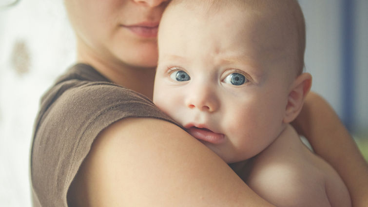 Mom hugs an infant