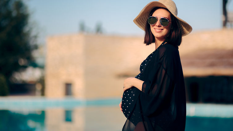 Pregnant Woman Relaxing on Vacation By The Pool