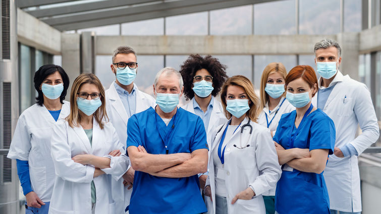 Group of doctors with face masks looking at camera, corona virus concept