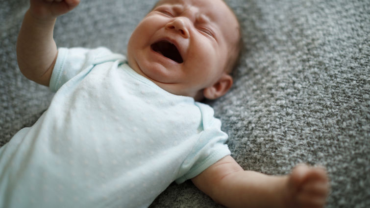 Little baby boy crying with opened mouth