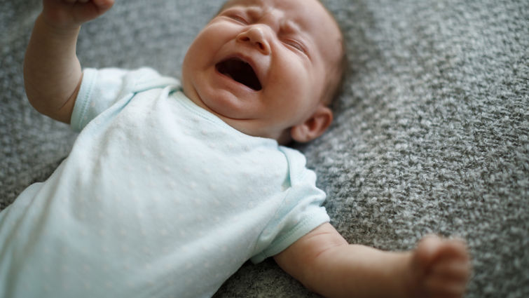 Little baby boy crying with opened mouth 