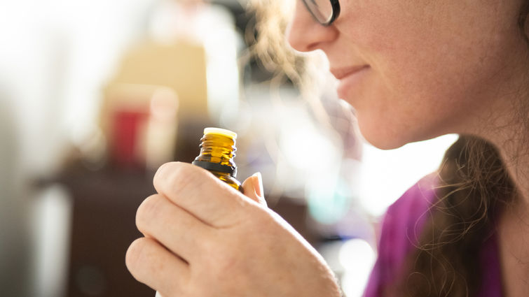 Woman smelling an essential oil