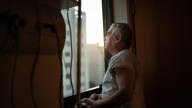 Senior patient looking out hospital window