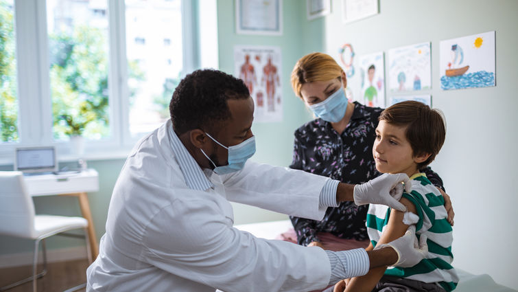 Close up of a pediatrician vaccinating his patient