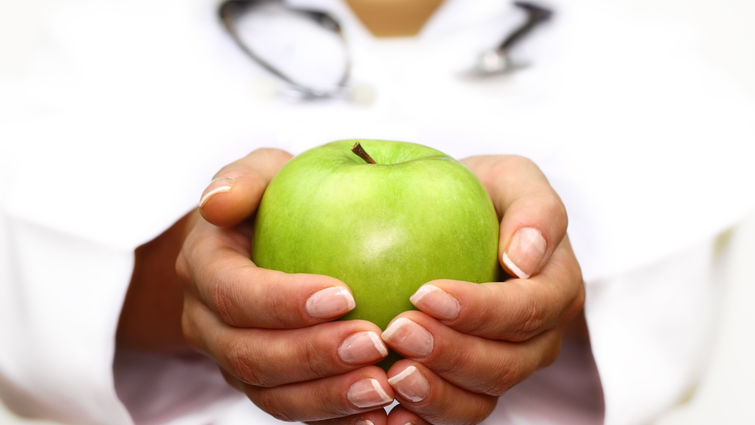 Hands holding an apple