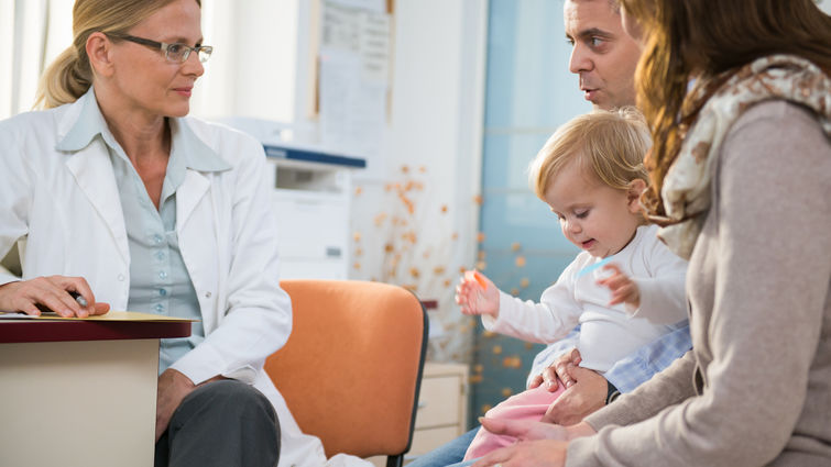 Pediatrician with baby and her Parents