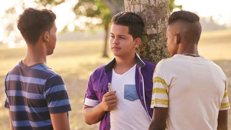 Young teens smoking outside