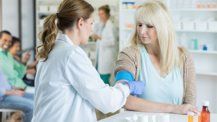female physician giving flu shot to female patient