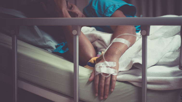 sick woman lying in hospital bed 