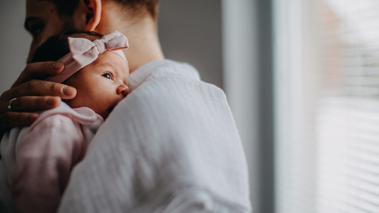 father holding infant baby