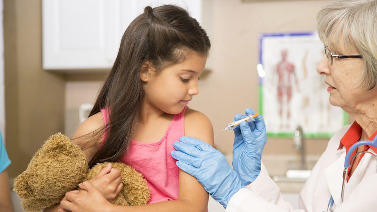 Young Hispanic girl gets a flu shot