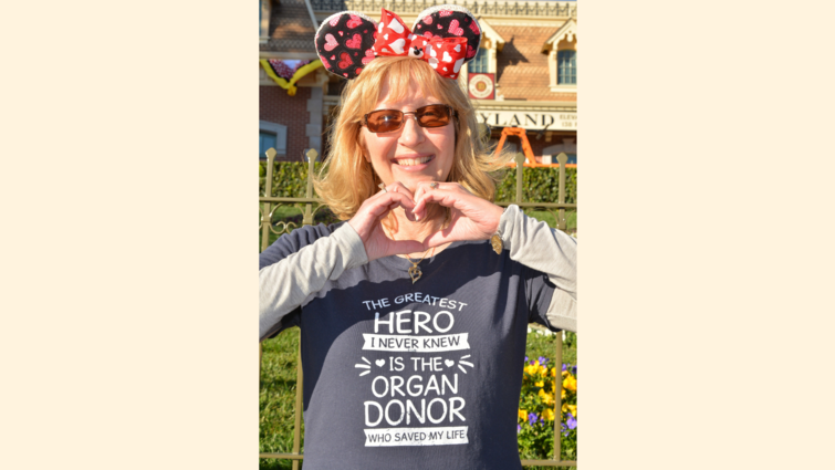 Julie Hutchinson makes a heart with her hands while wearing an organ donor appreciation shirt. Julie Hutchinson makes a heart with her hands while wearing an organ donor appreciation shirt