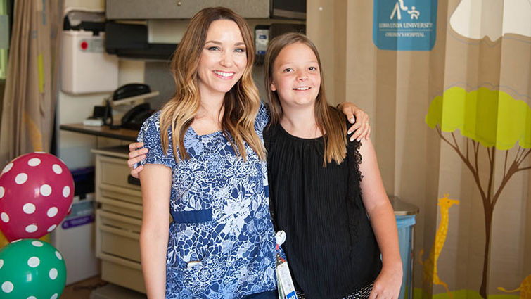 Josslyn Tramel embraces Janelle Cicero, RN at Loma Linda University Children's Hospital who stood by her side during her hospital stay.