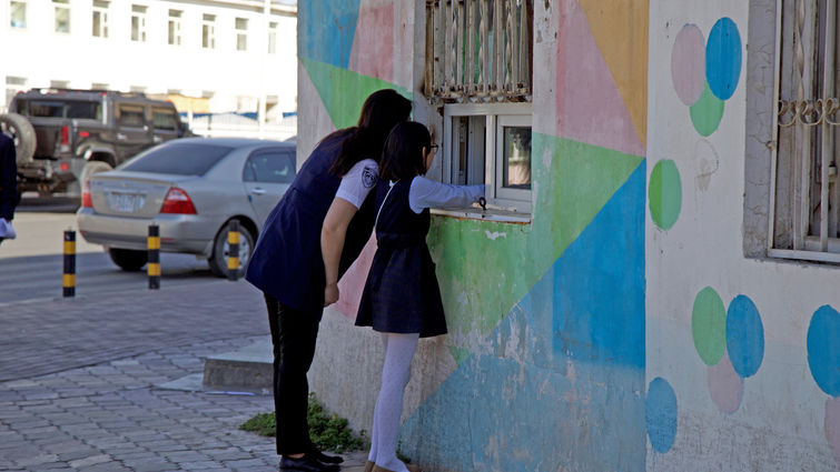 Child buying out of a window.