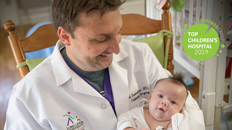 physician holds infant patient