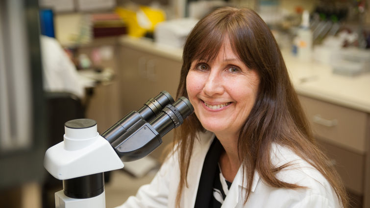 White female physician in a medical lab. 