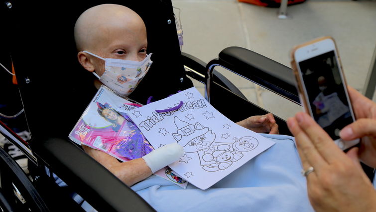 LLUCH patient, Mia Capuano, 10, from Menifee, loads up on goodies during the Spirit of Children Fall Festival. child