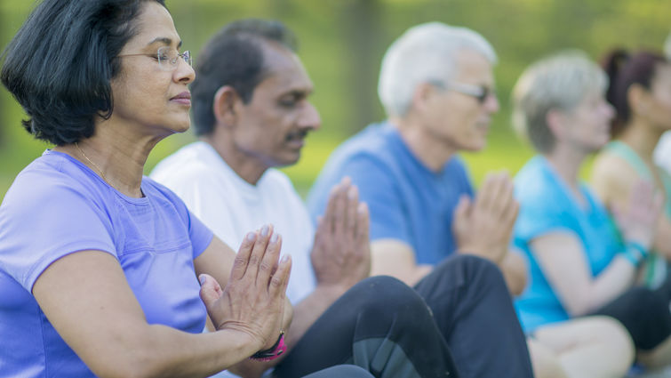 group of people doing a namaste pose