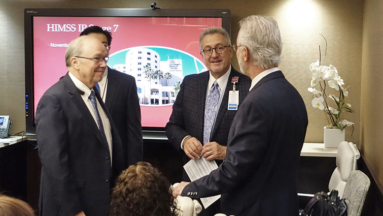 From left, CIO Mark Zirkelbach, MPA, and CEO Kerry Heinrich, JD, speak with surveyor Philip Bradley when the HIMSS team visited Nov. 7 and granted Stage 7 status for inpatient electronic medical record adoption.