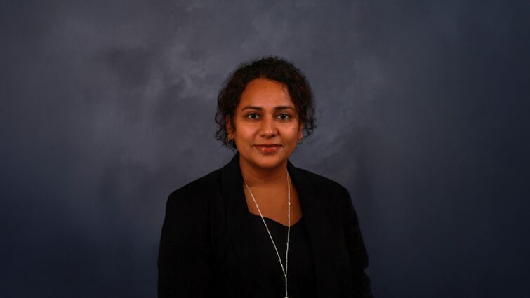 Indian woman with dark hair, black professional attire portrait headshot