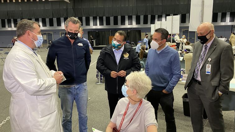 Community member Barbara Wurth, seated, met with Gov. Gavin Newsom and other elected officials while getting her coronavirus vaccine at the Drayson Center on Wednesday, Feb 17. Governor Gavin Newsom visits community vaccine clinic