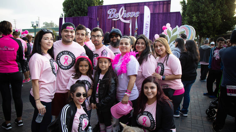 family standing in front a believe sign