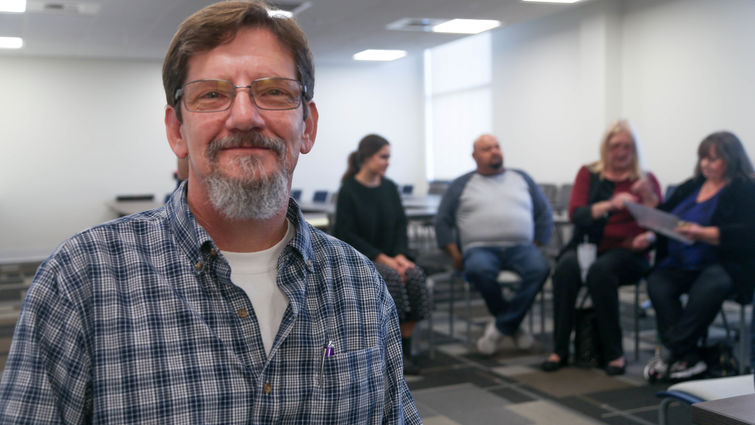 man with a support group behind him