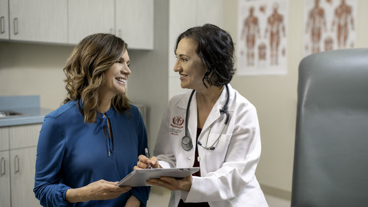 Doctor reviews paperwork with patient. 