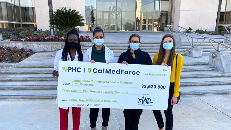 Cal Med Force grant LLUH residents accept check from Cal Med Force