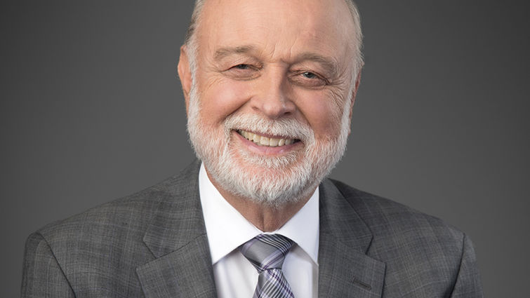 Man smiles in formal portrait