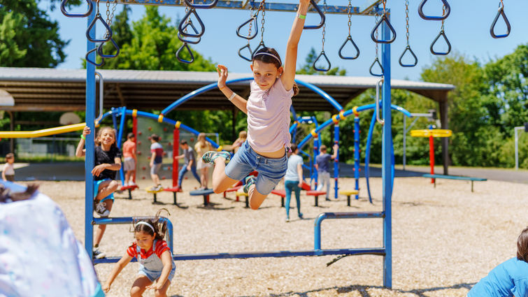 Kids playing on a playground during summer